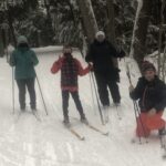 Four skiers looking at camera at Cole's Woods
